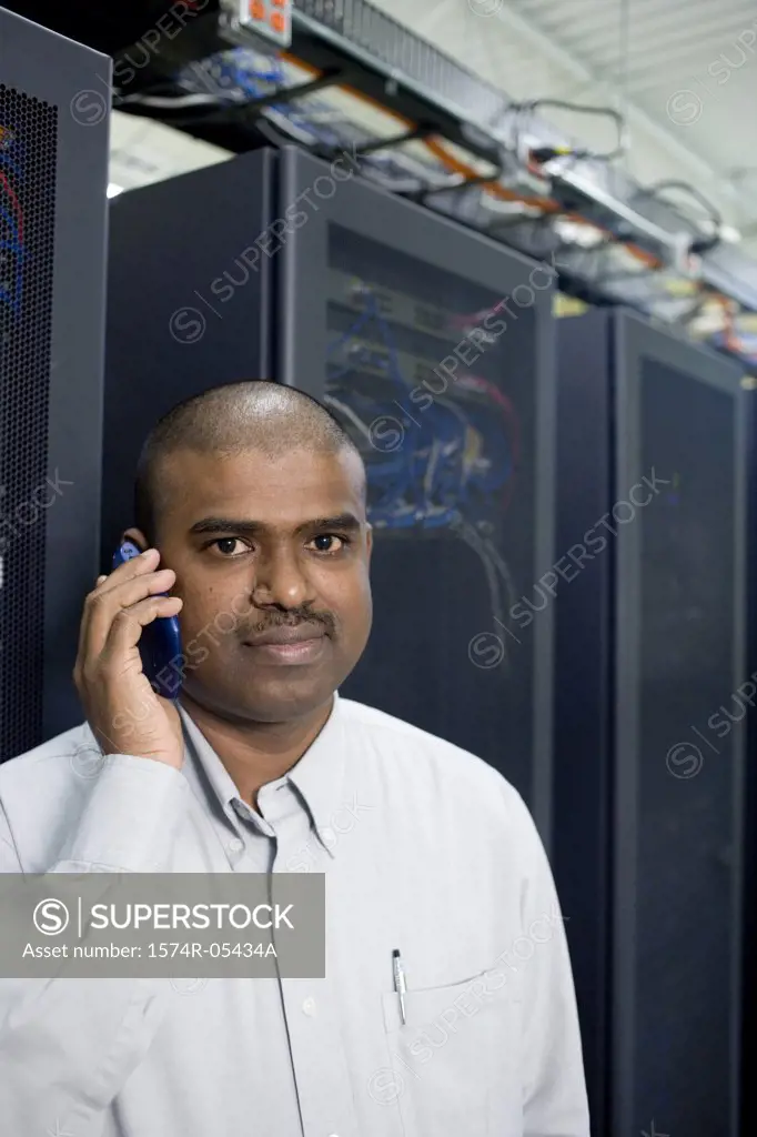 Portrait of a male technician using a mobile phone