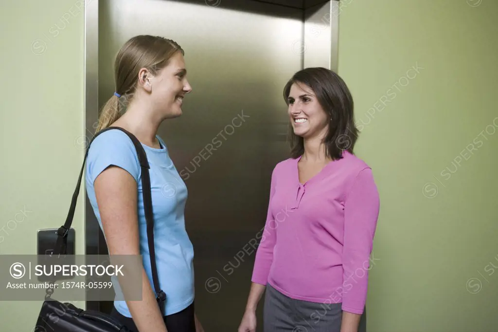 Two businesswomen waiting for an elevator