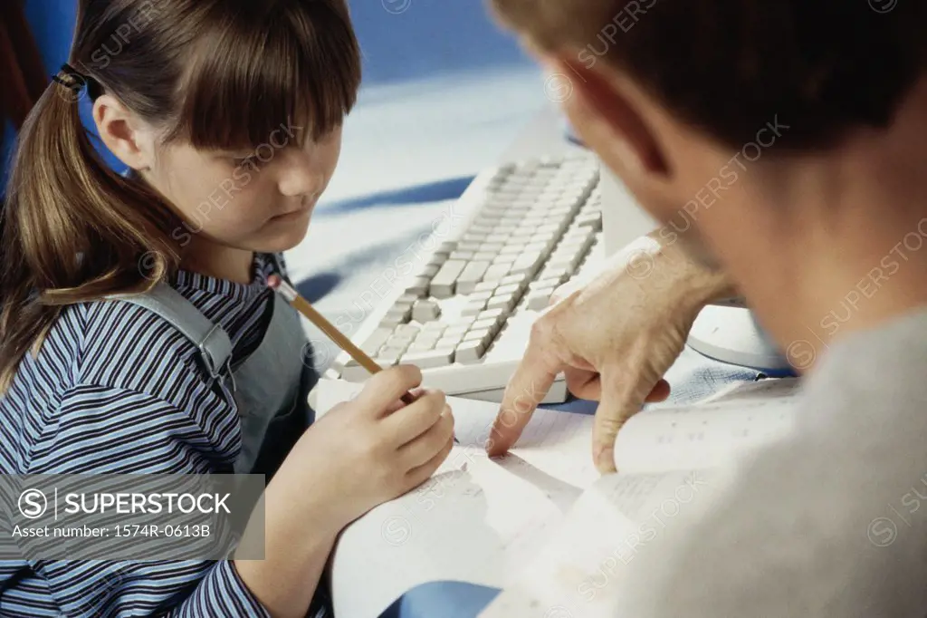 Father helping his daughter with homework