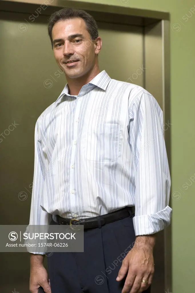 Portrait of a businessman standing near an elevator