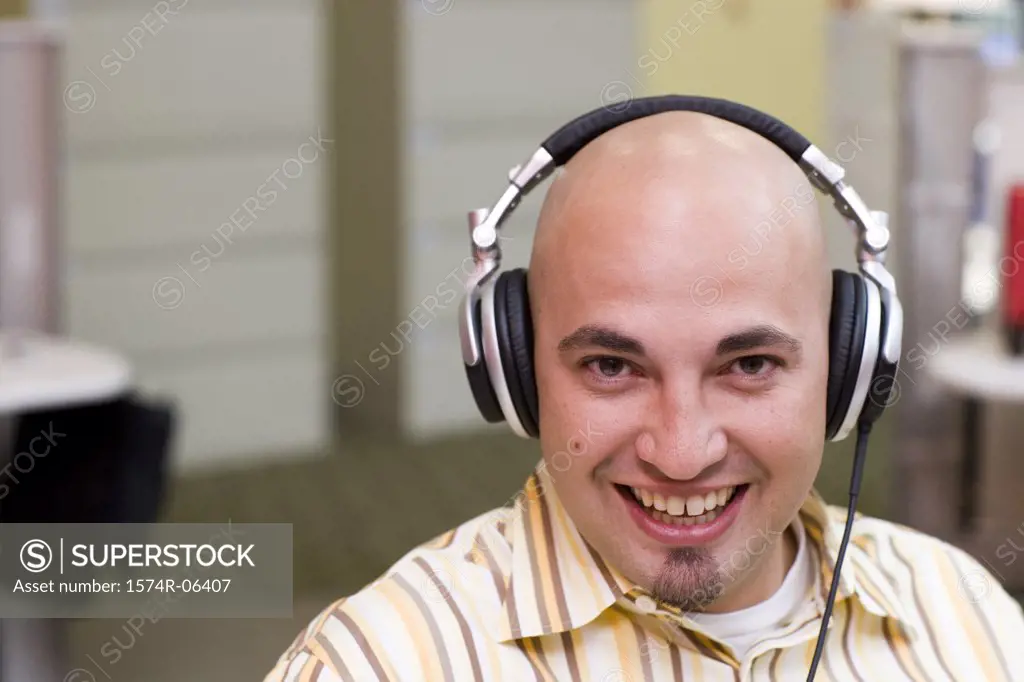 Portrait of a businessman wearing headphones in an office