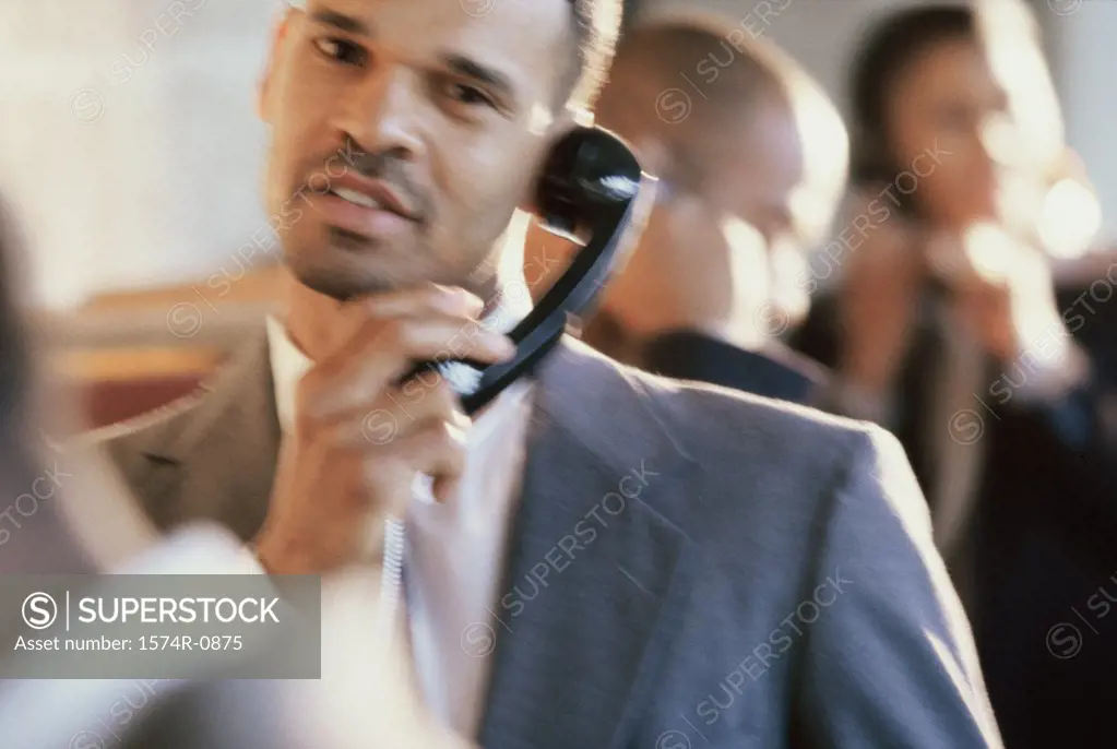 Close-up of a businessman talking on a landline telephone