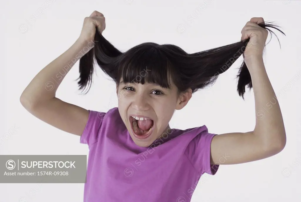 Portrait of a girl pulling her hair