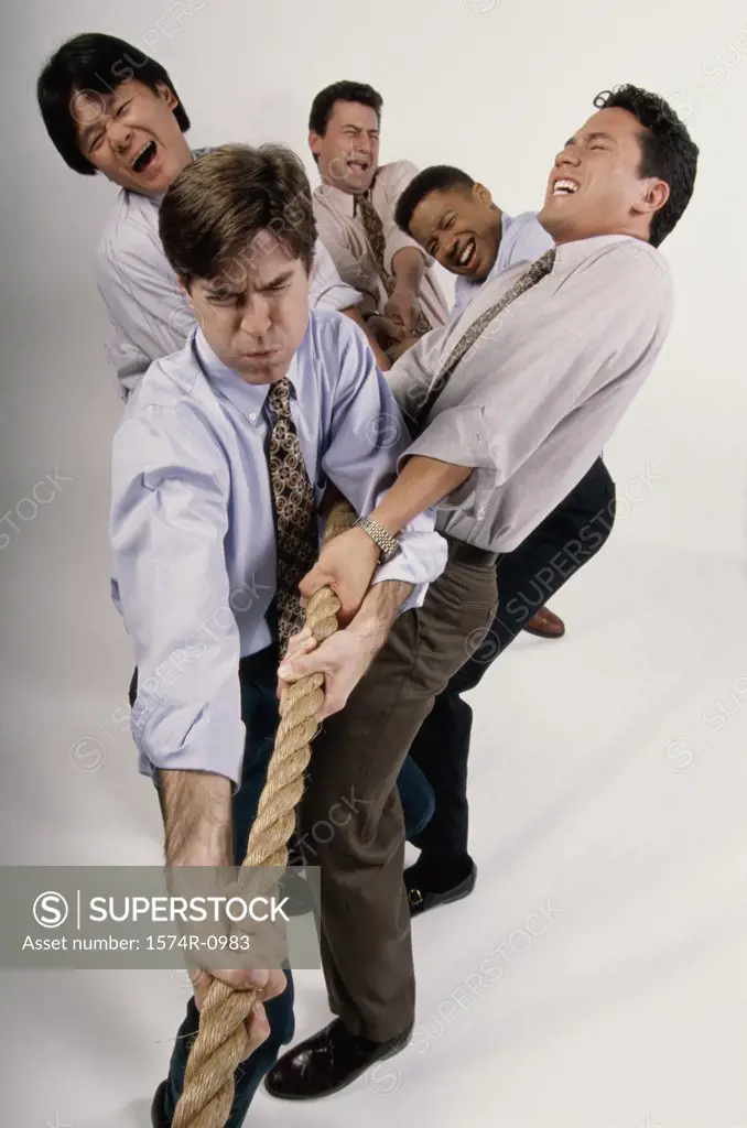 Group of businessmen playing tug-of-war