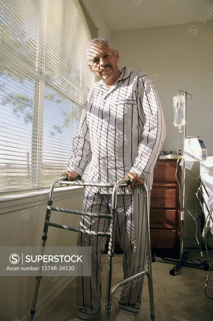 Portrait of a senior man walking with a walker