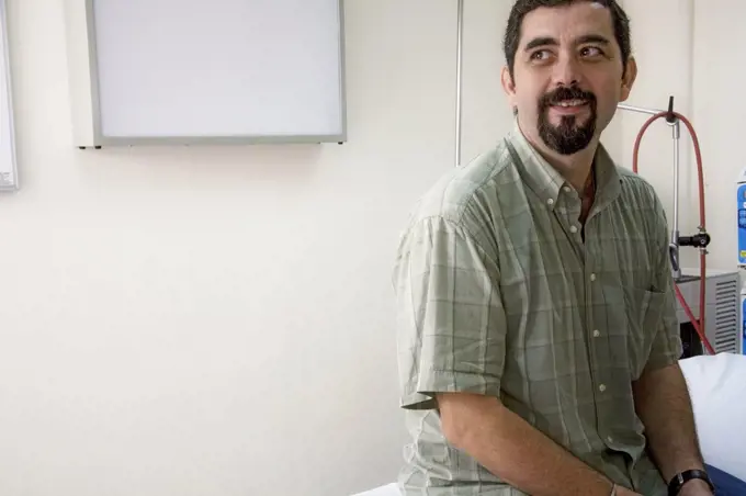 Patient sitting in a hospital room and smiling