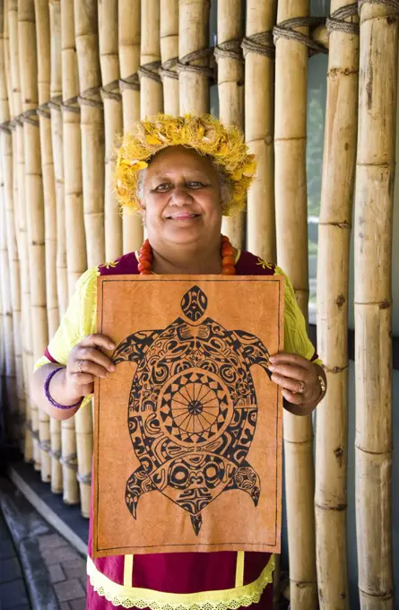 Portrait of a woman holding a wall hanging, Papeete, Tahiti, French Polynesia