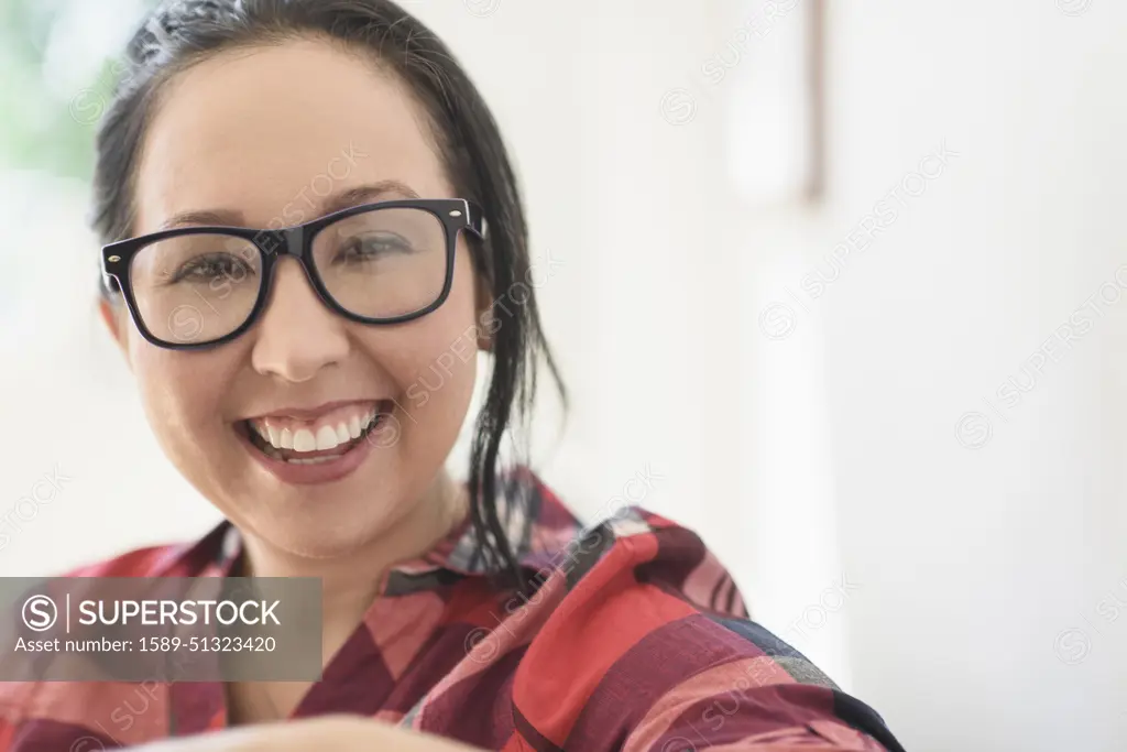 Smiling mixed race woman wearing eyeglasses