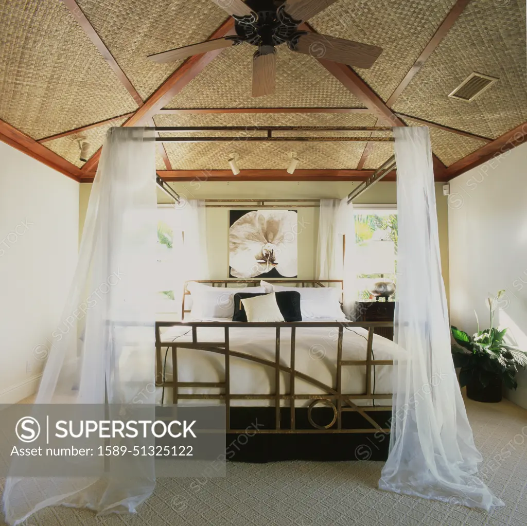 Hawaiian bedroom with mosquito netting around bed