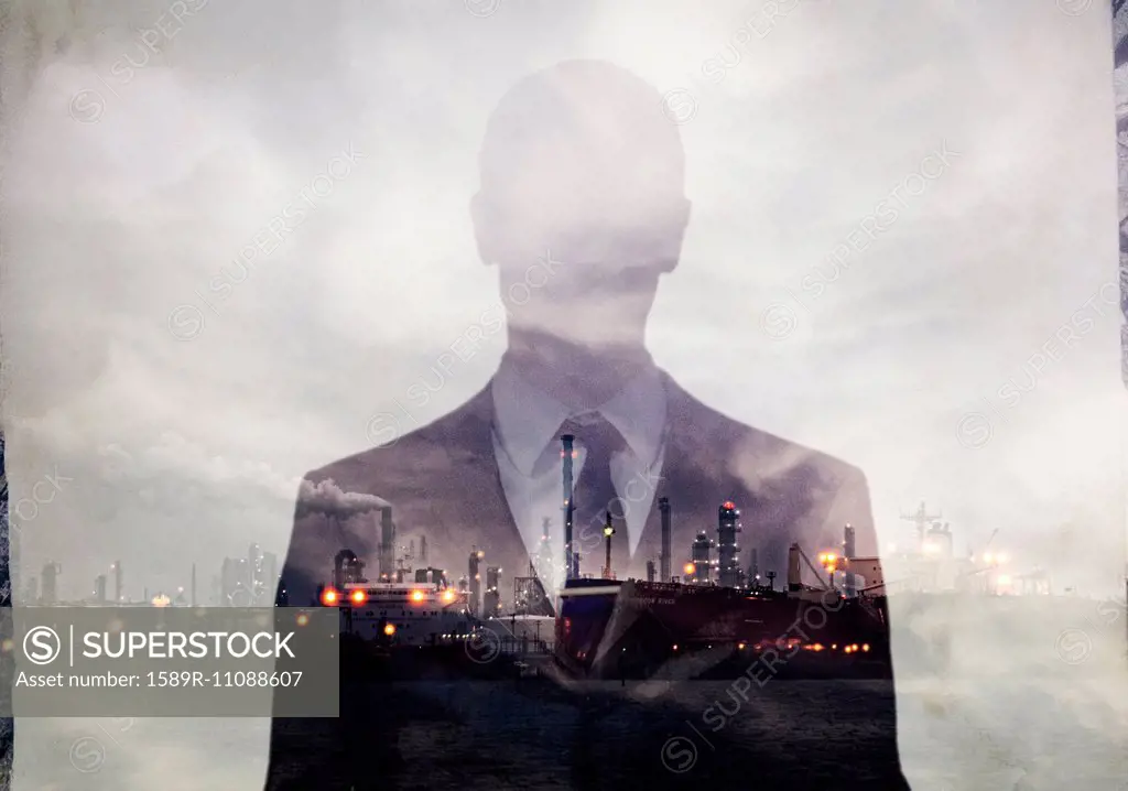 Double exposure of businessman and power plant