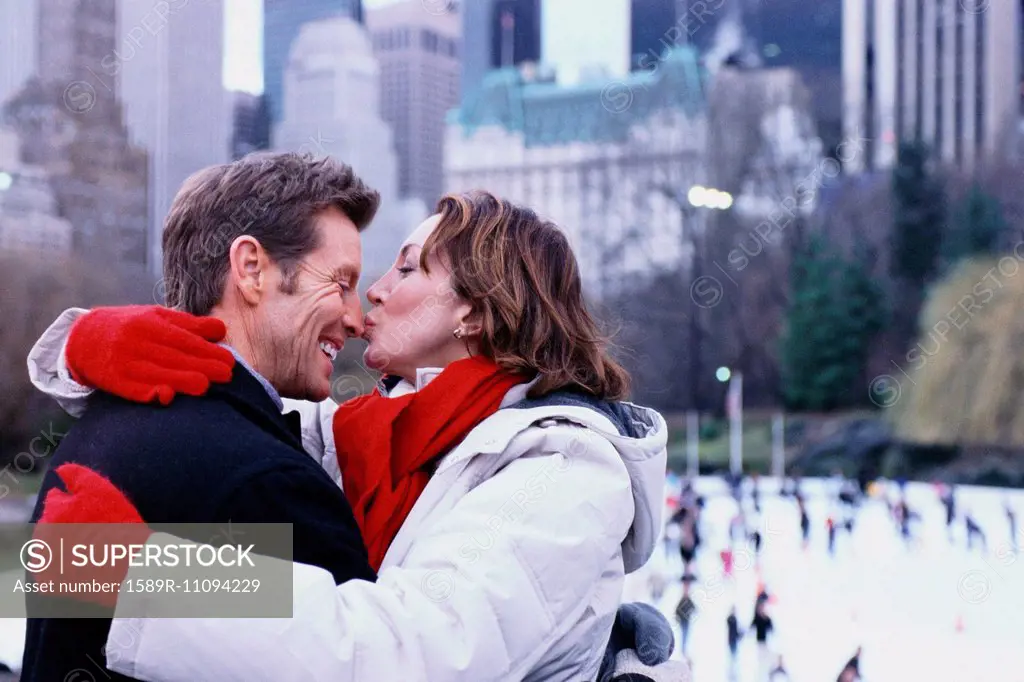Couple kissing outside Rockefeller Center, New York City, New York, United States