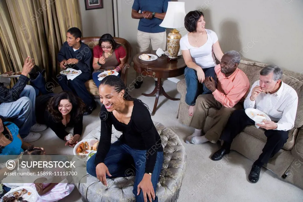 Multi-generation family relaxing together in living room