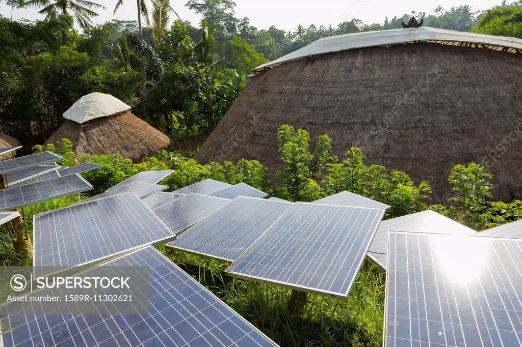 Solar panels among thatched roof buildings