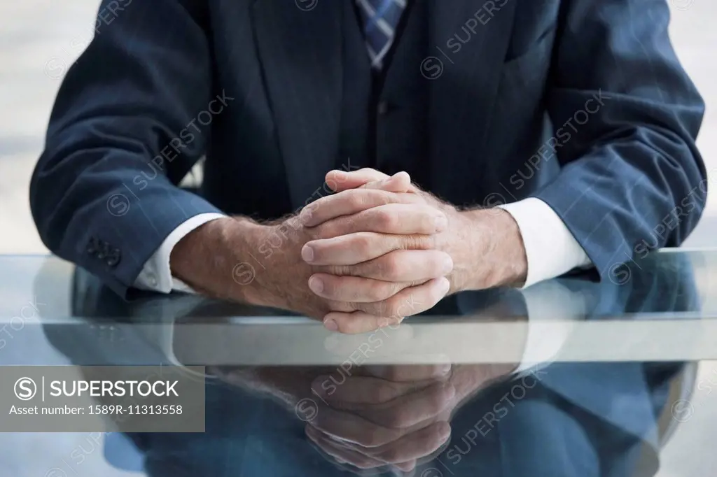 Senior Caucasian businessman's folded hands