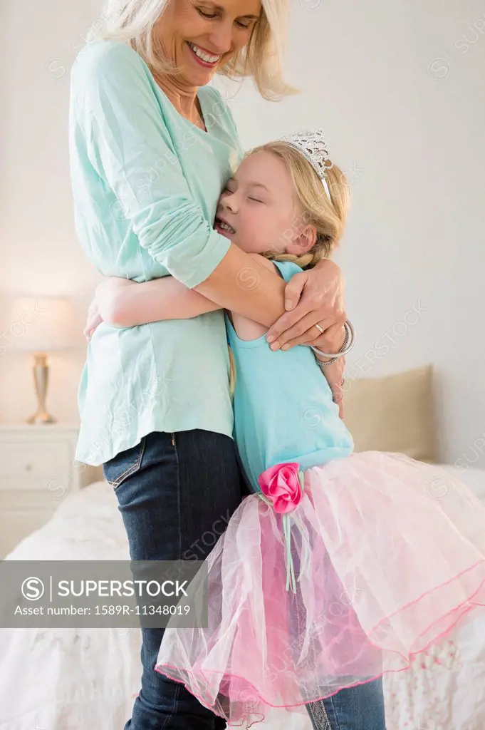 Senior Caucasian woman and granddaughter hugging