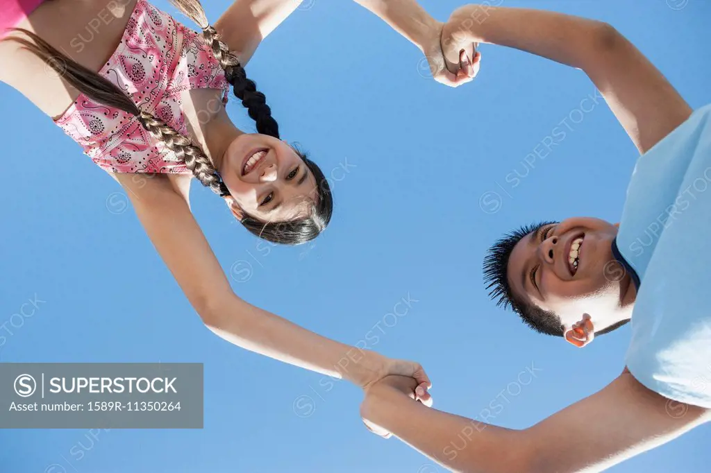 Hispanic children playing outdoors