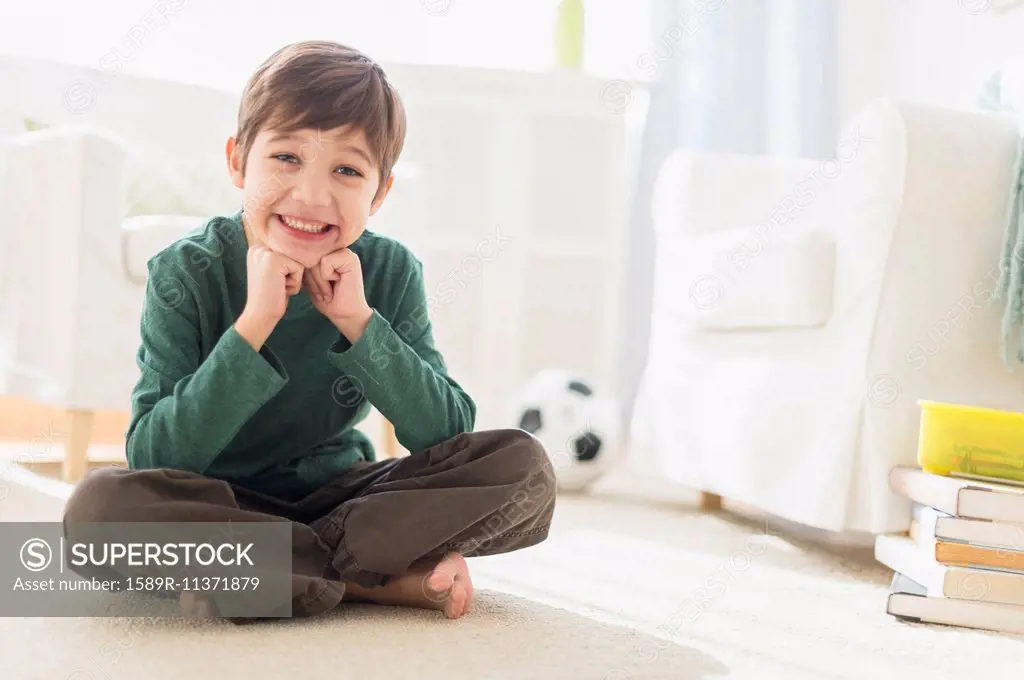 Hispanic boy smiling in living room