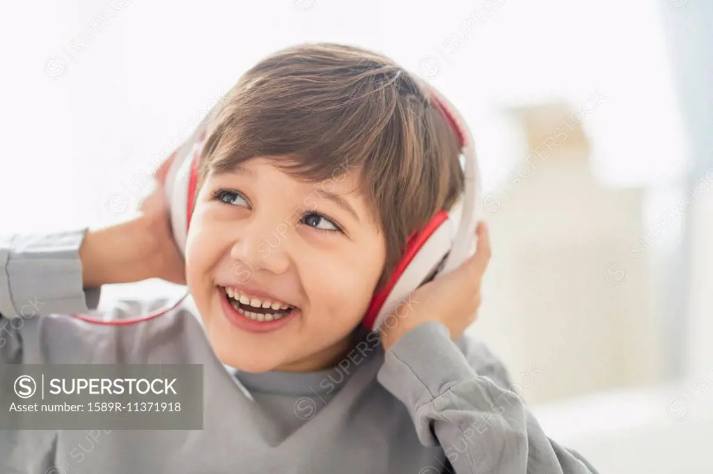 Hispanic boy listening to headphones