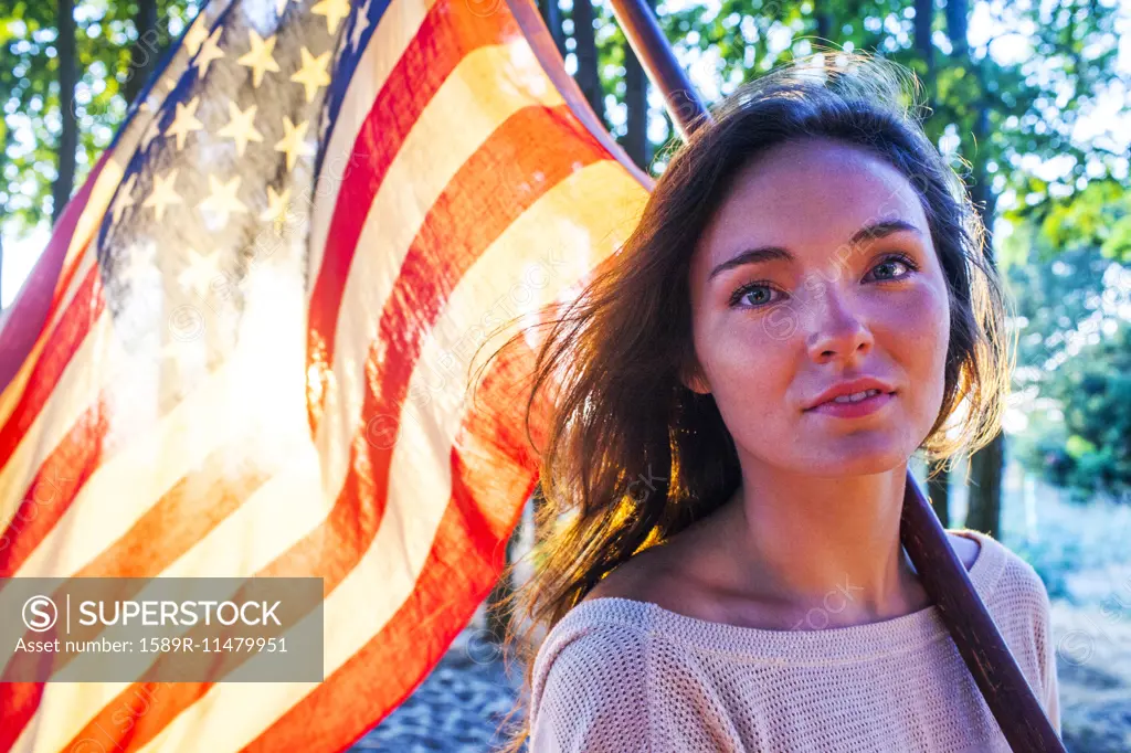 Caucasian woman holding American flag