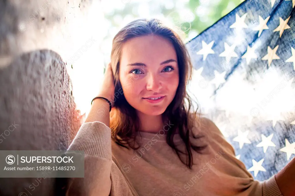 Caucasian woman holding American flag outdoors