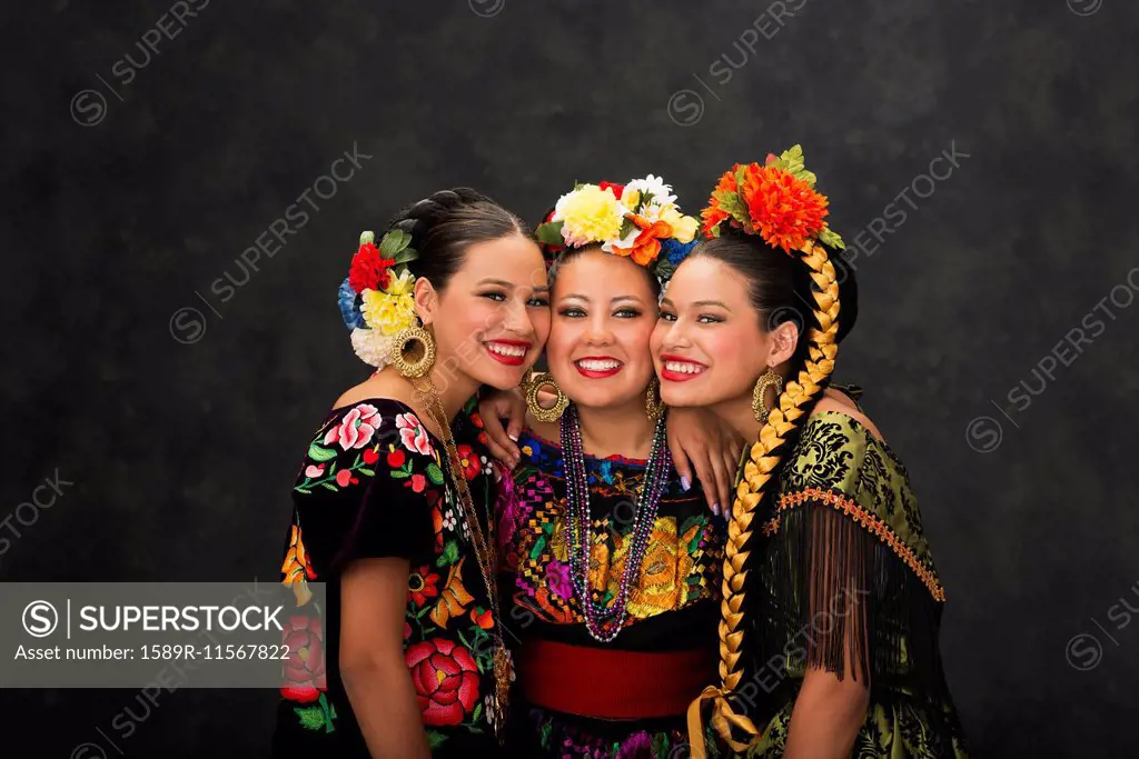 Hispanic teenage girls smiling in Sinaloa, Chiapas and Jallisco Folkloric dress