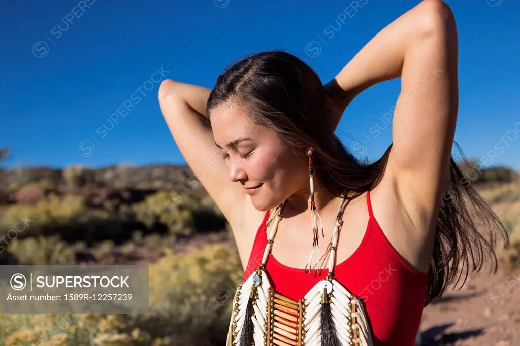 Mixed race woman standing in remote desert landscape