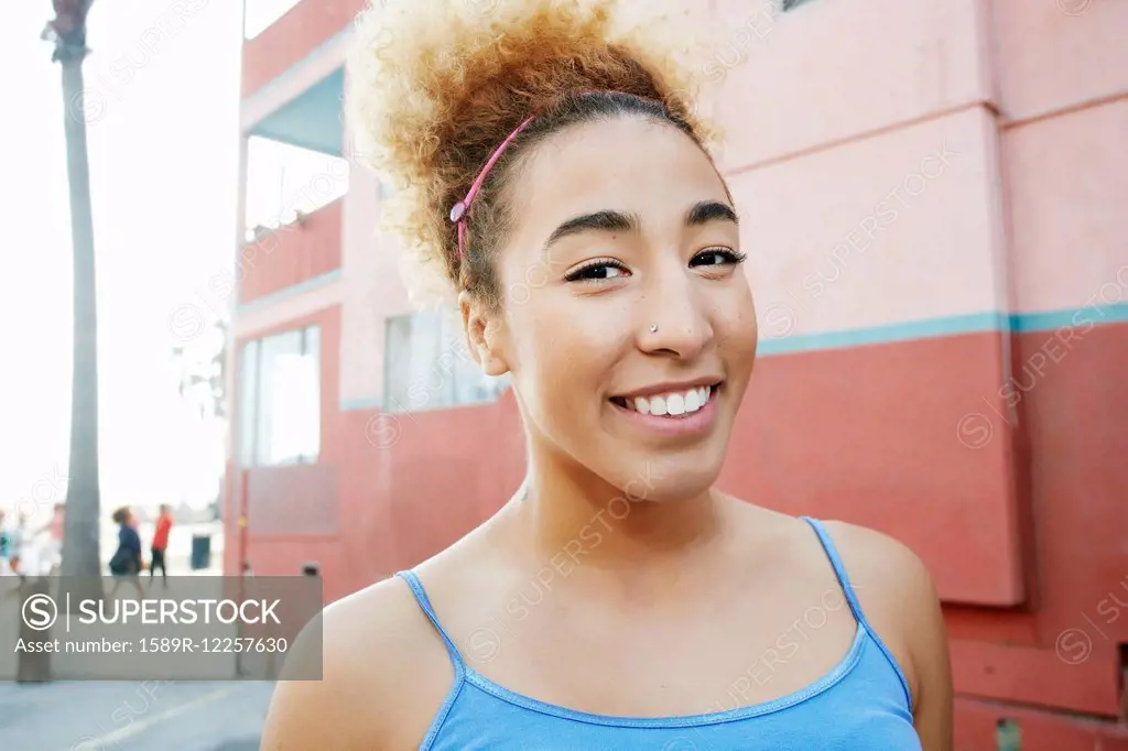 Hispanic woman smiling in city