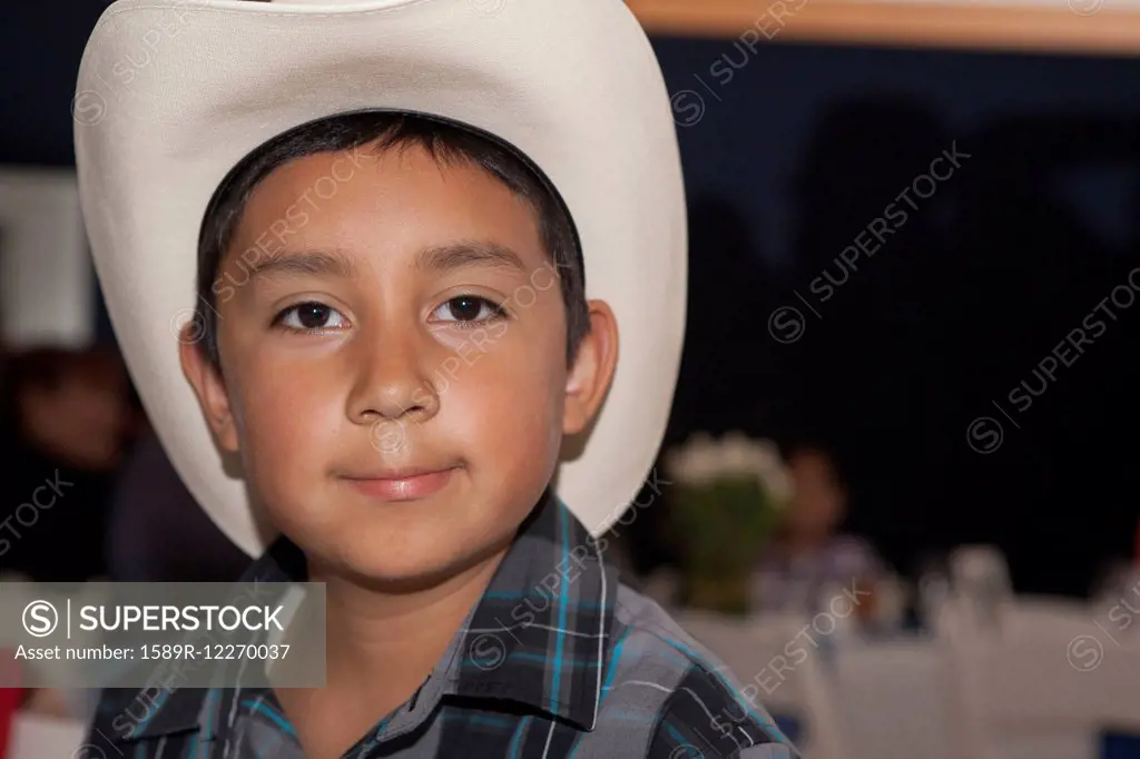 Hispanic boy wearing cowboy hat