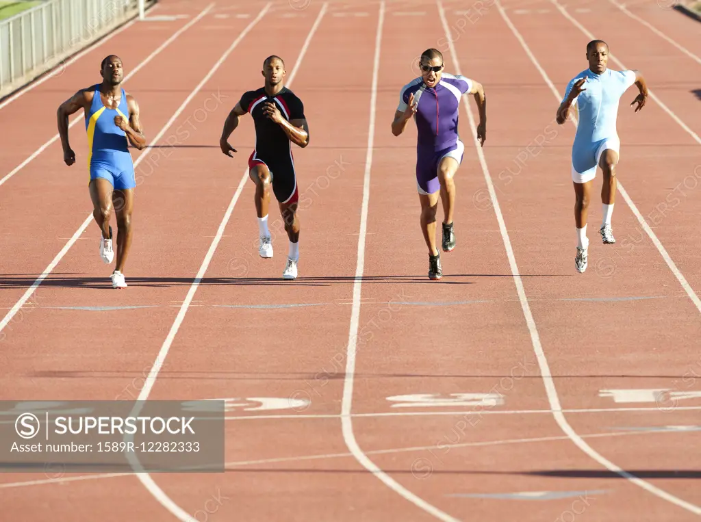 Runners running on track in race