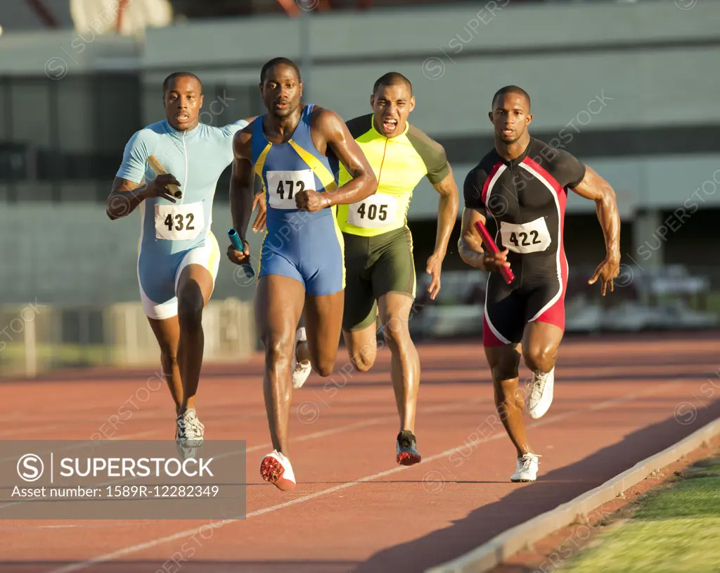 Relay racers running on track in race