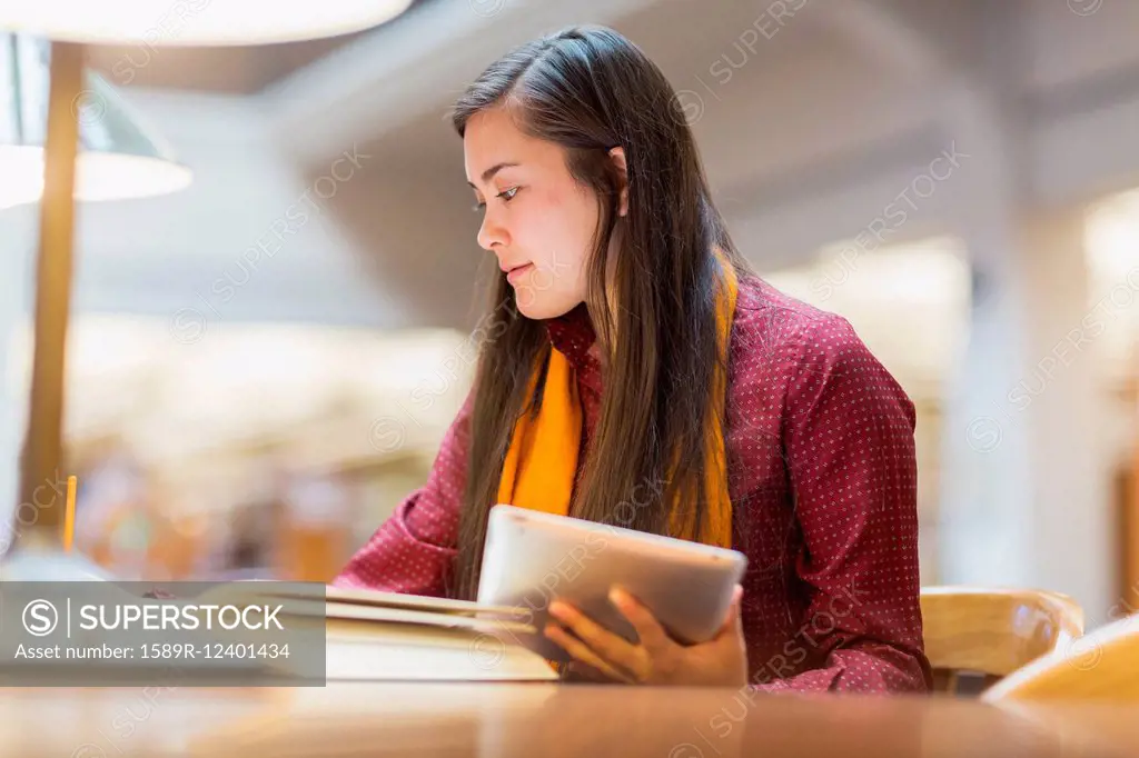 Mixed race student studying in library