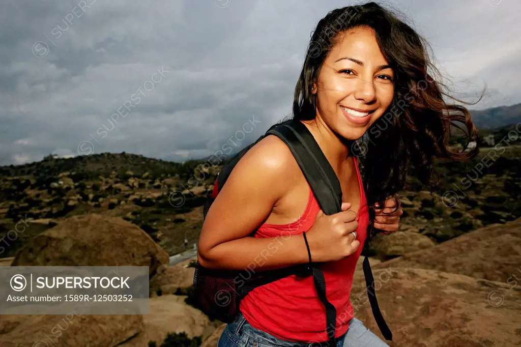 Hispanic woman smiling on rock formation