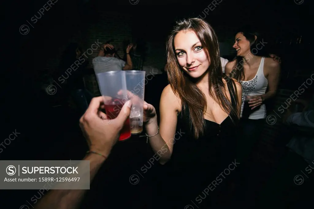 Friends toasting and drinking in nightclub