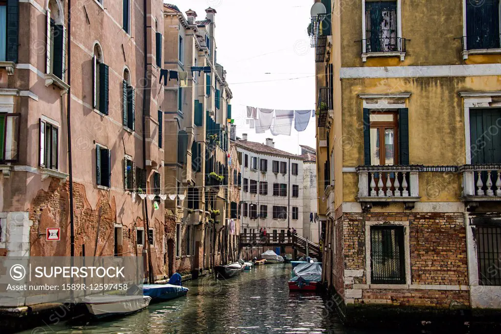 Clotheslines over canal between apartment buildings, Venice, Italy