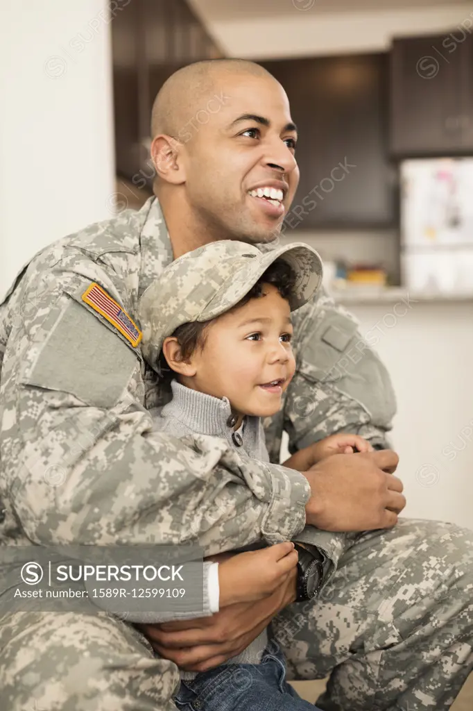 Mixed race soldier father hugging son