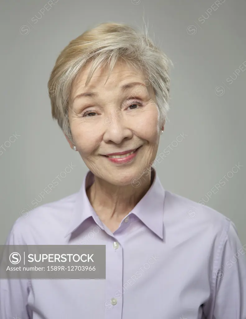 Close up of older Japanese woman smiling - SuperStock