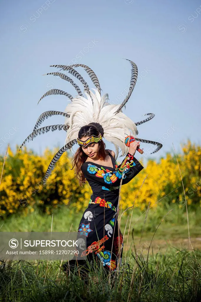 Native American woman in traditional headdress performing ceremony