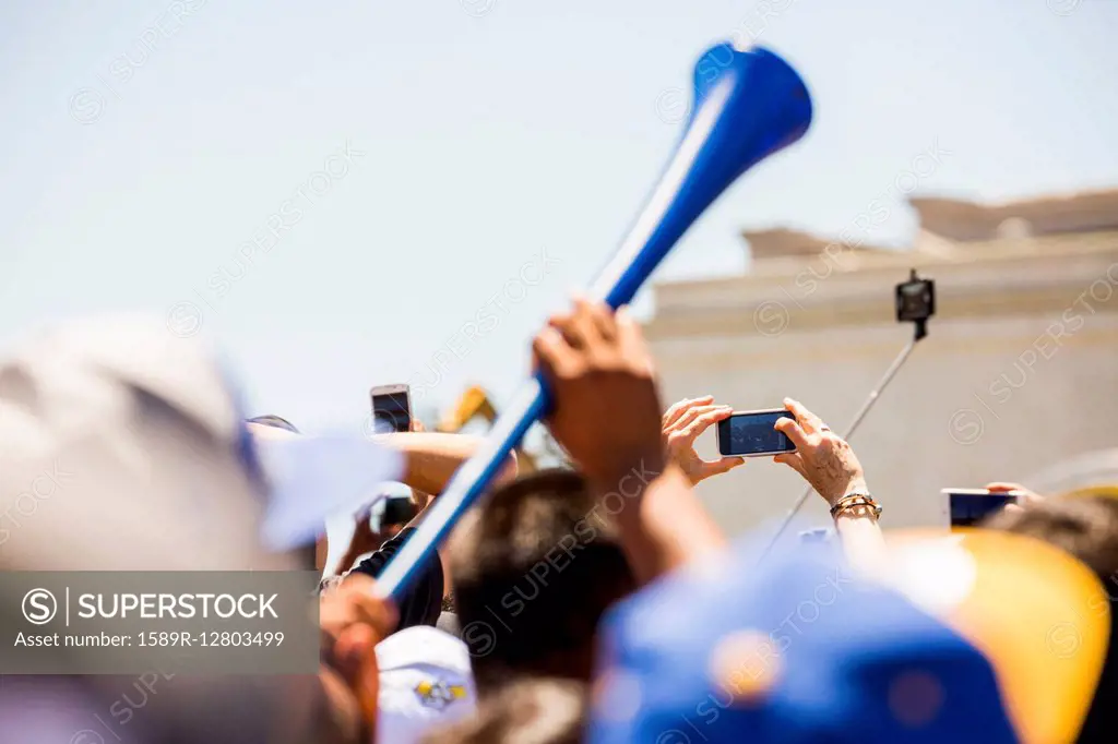 Crowd of fans cheering at sporting event