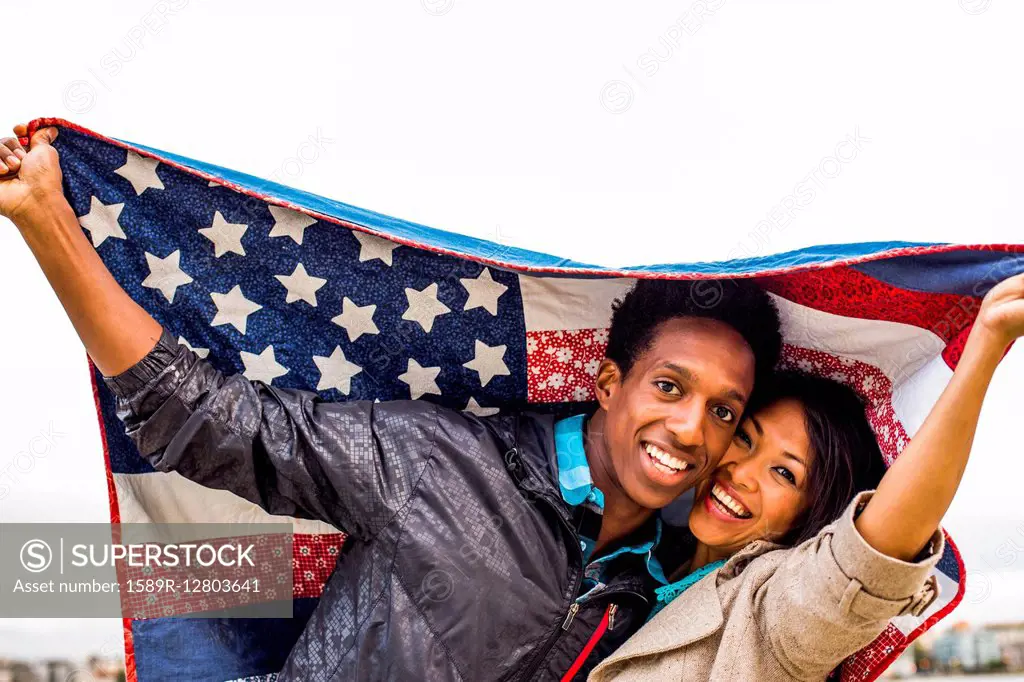 Couple holding American flag quilt outdoors