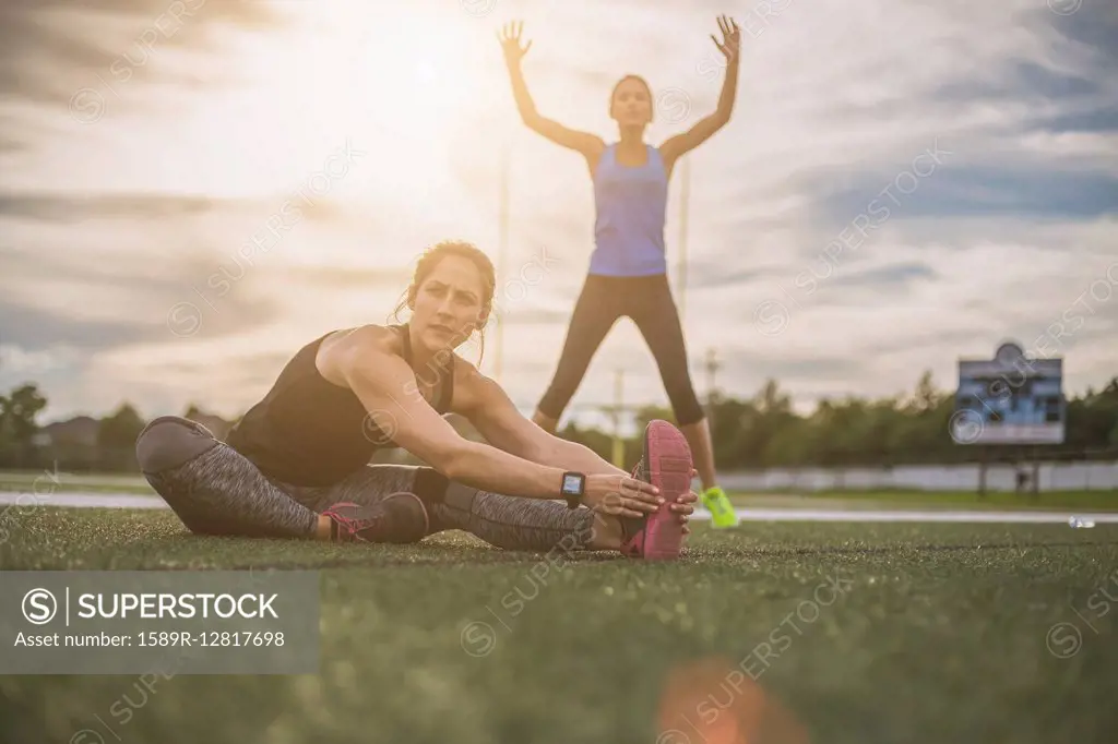 Athletes stretching on sports field