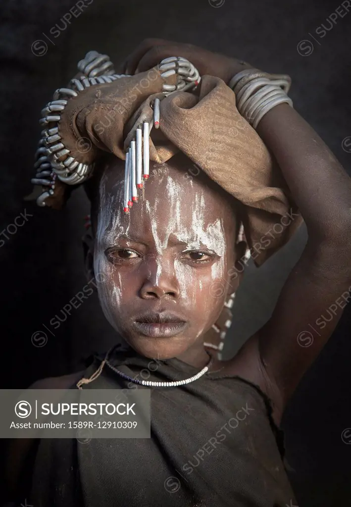 Black child wearing traditional face paint
