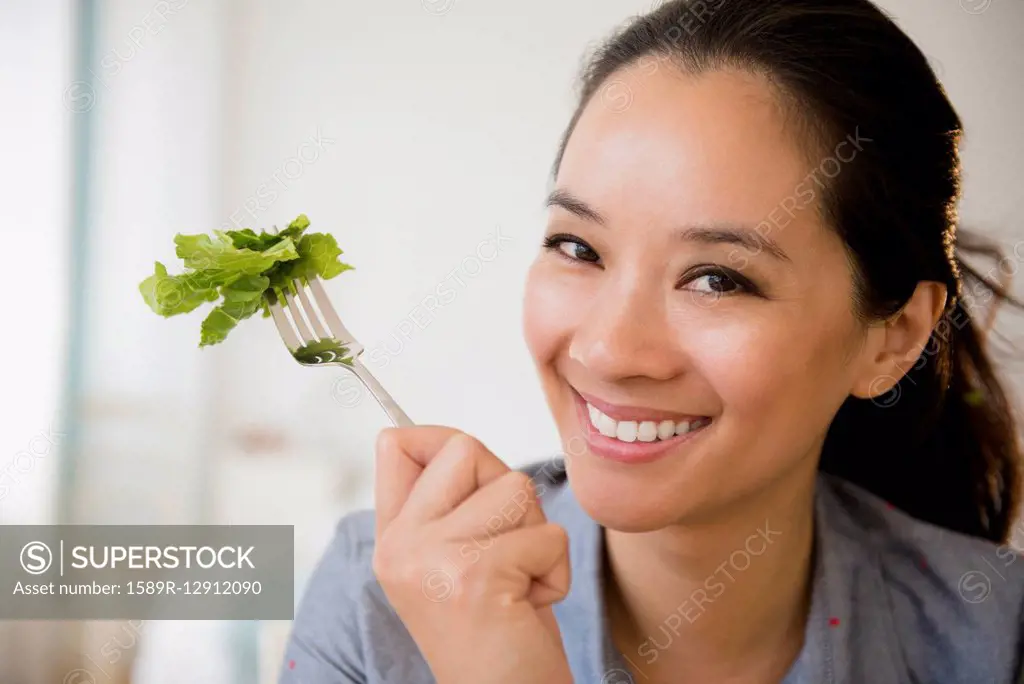 Chinese woman eating salad