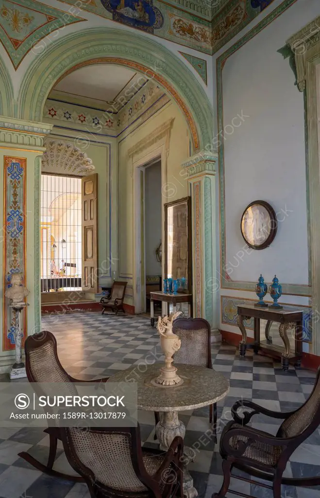 Table and chairs in ornate room