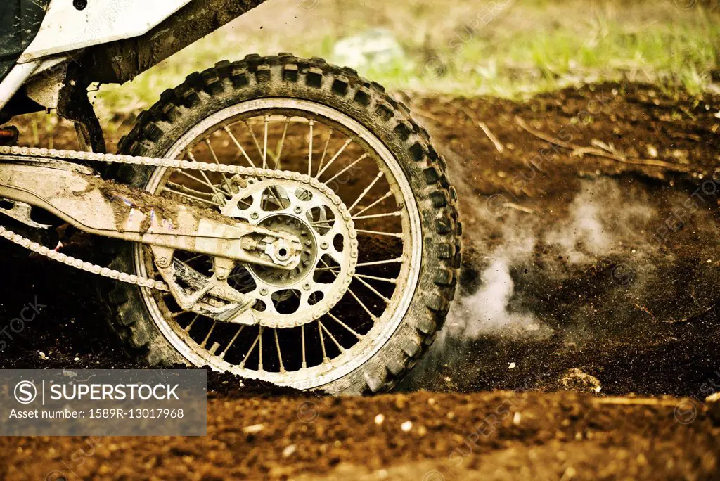 Dirt bike tire smoking in dirt