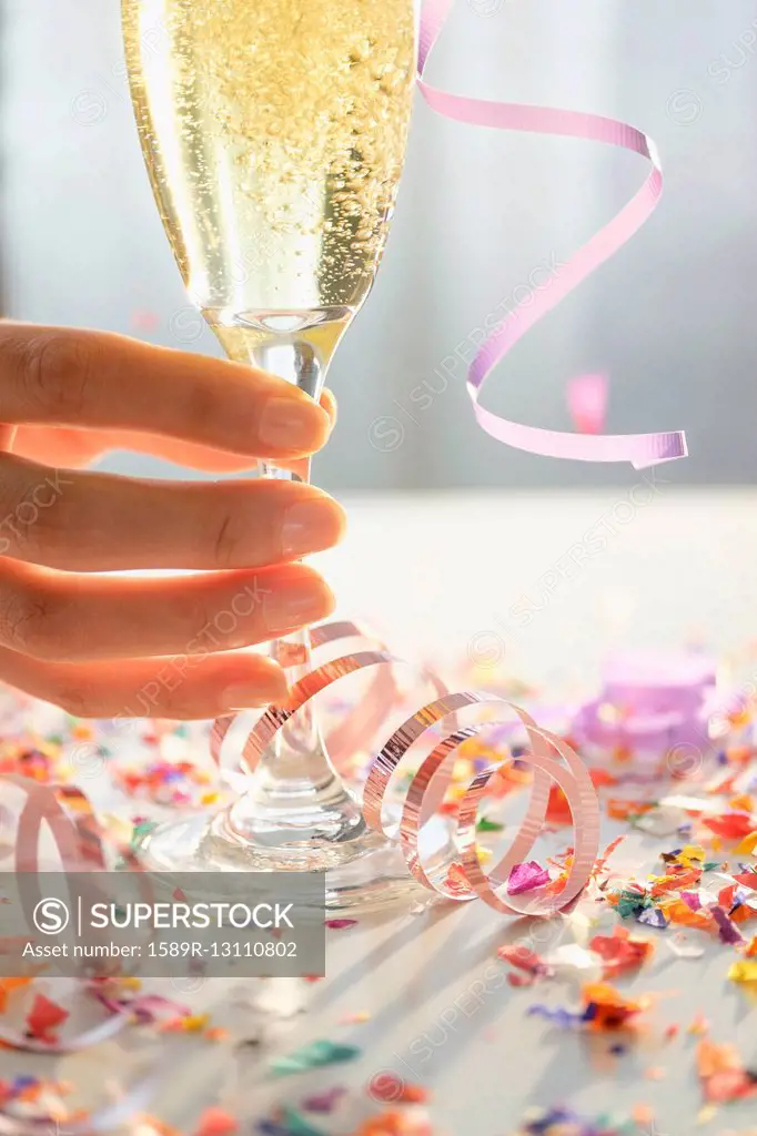 Hispanic woman holding glass of champagne