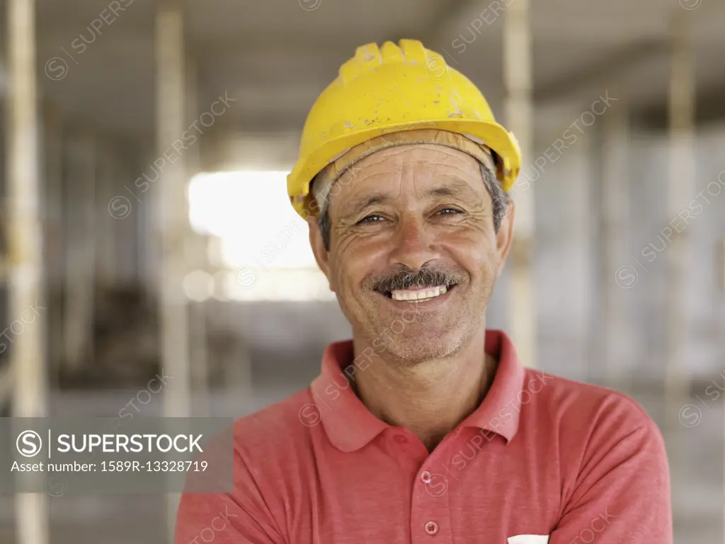 Hispanic worker smiling on construction site