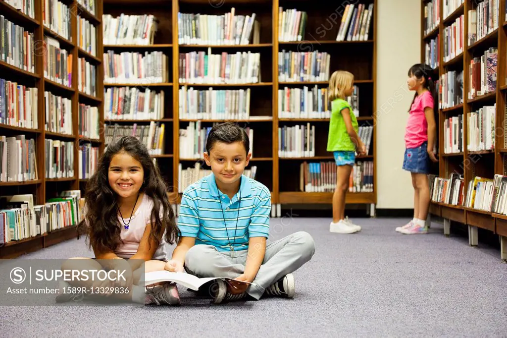 Children sitting on library floor