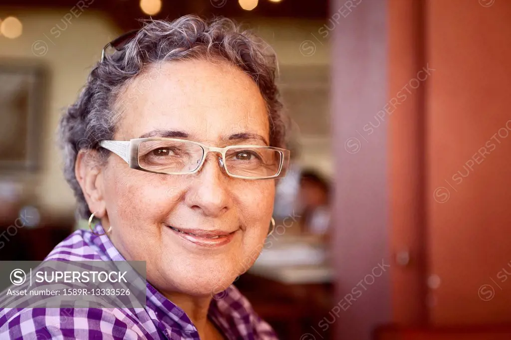 Smiling Hispanic woman wearing eyeglasses