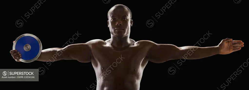 African American man holding track and field discus