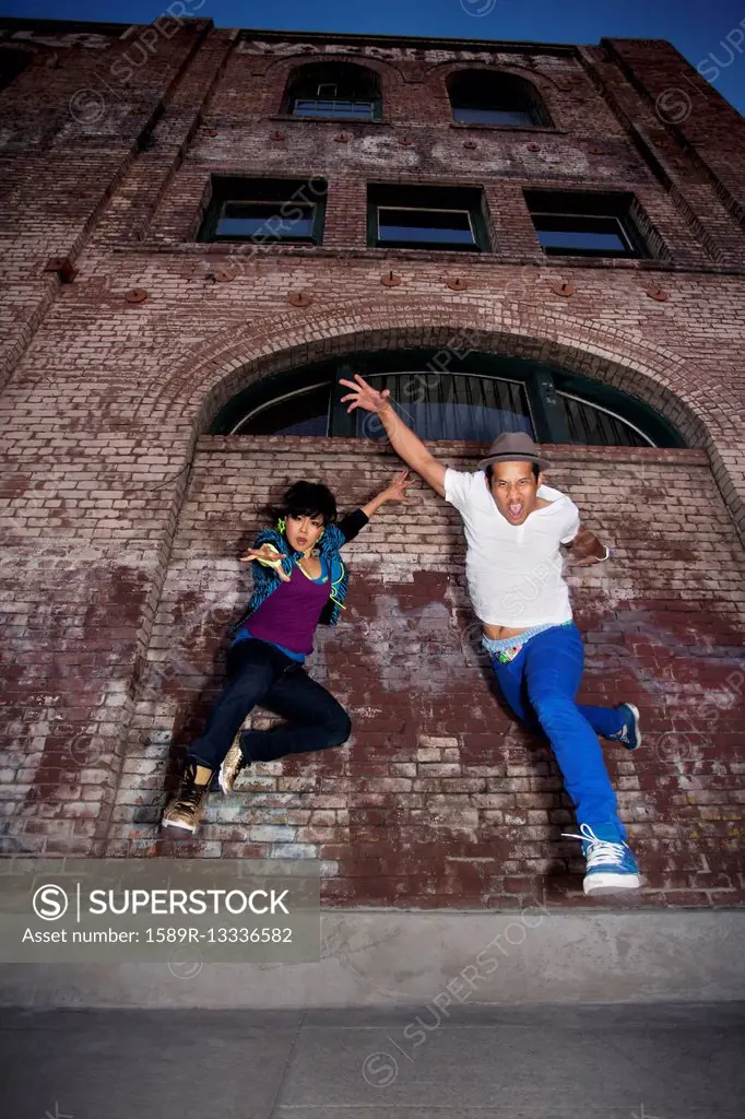 Couple breakdancing in urban area